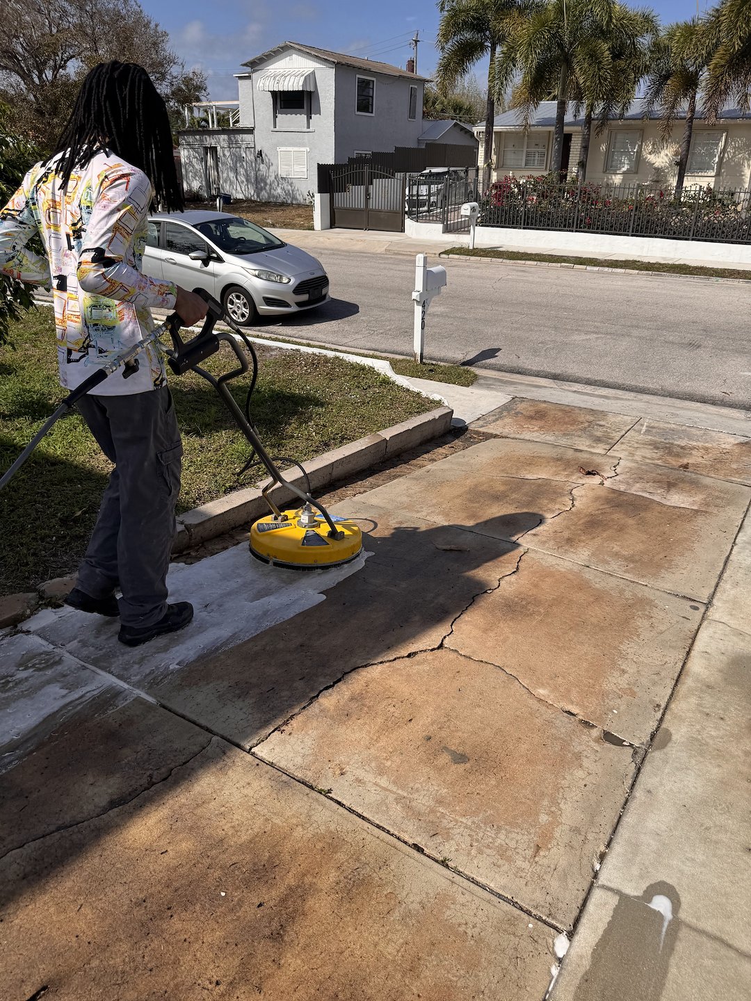 Pressure Cleaning/ Pressure washing of Concrete driveway, concrete patio and firepit located in West Palm Beach FL 33405.
